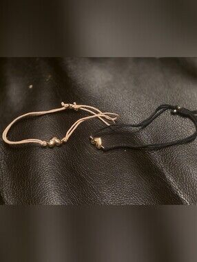 Pair Of Heart Charm Bracelets On Beige & Black Cord